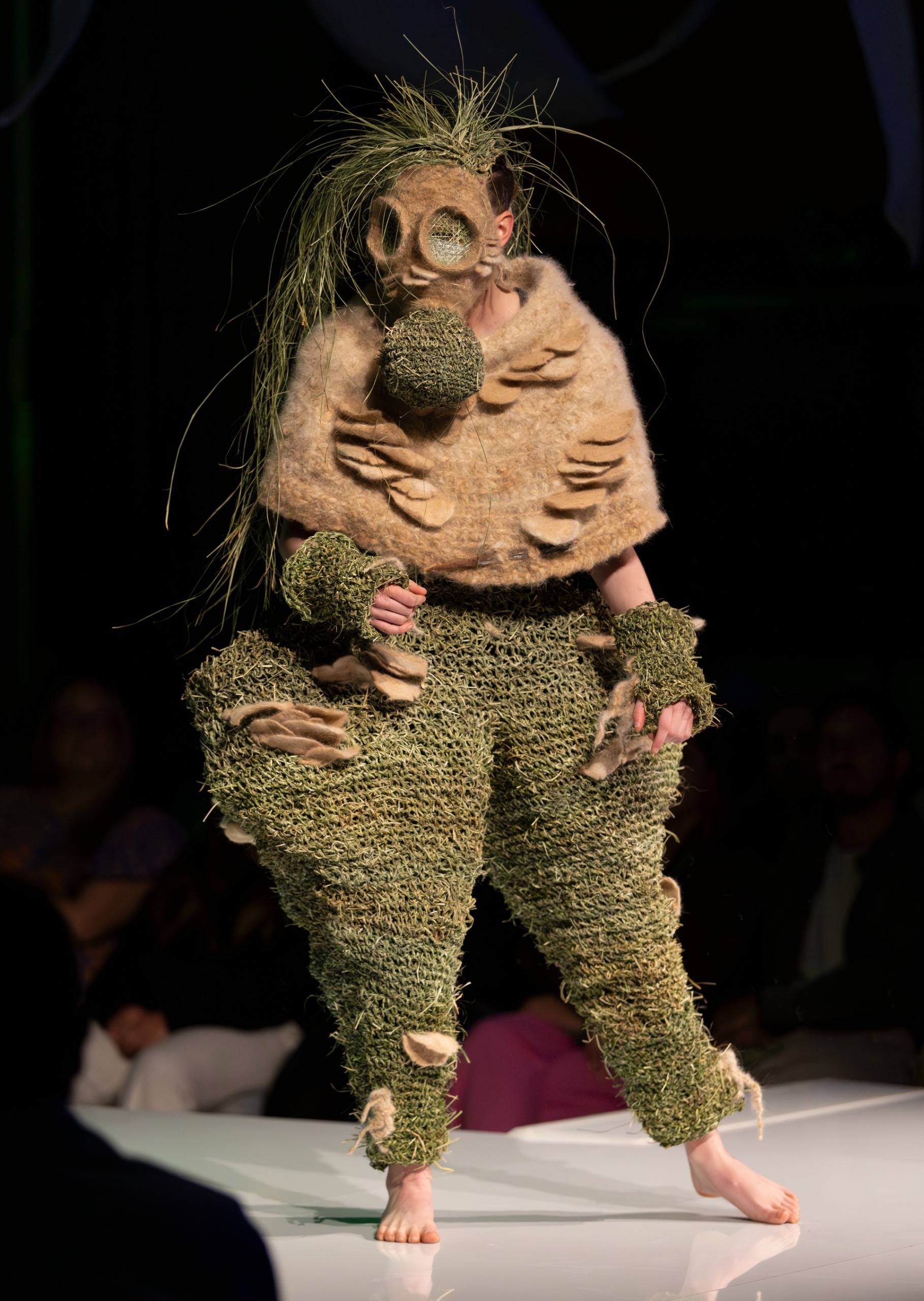 ​​Artist​​:​ Stephanie Vale ​Title: ​Gather Community  Judges' comments: A stunning woven piece made from grass tree fibres and felted poodle hair, shaped around the body like fungi forms. Beautifully made and conceptually strong, highlighting ecology and shared responsibility for environmental care.​